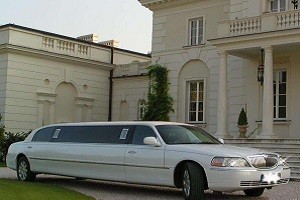 The white Lincoln Towncar limousine outside a stately building in Gdansk, Poland